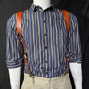 A man wearing a blue and yellow striped shirt with brown leather double shoulder suspenders.