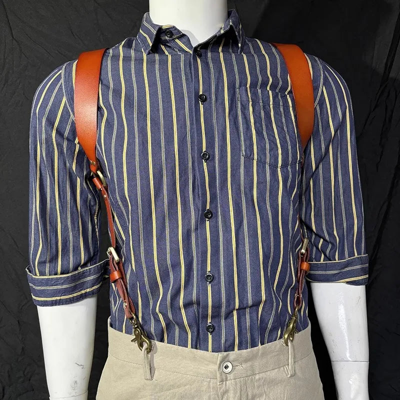A man wearing a blue and yellow striped shirt with brown leather double shoulder suspenders.