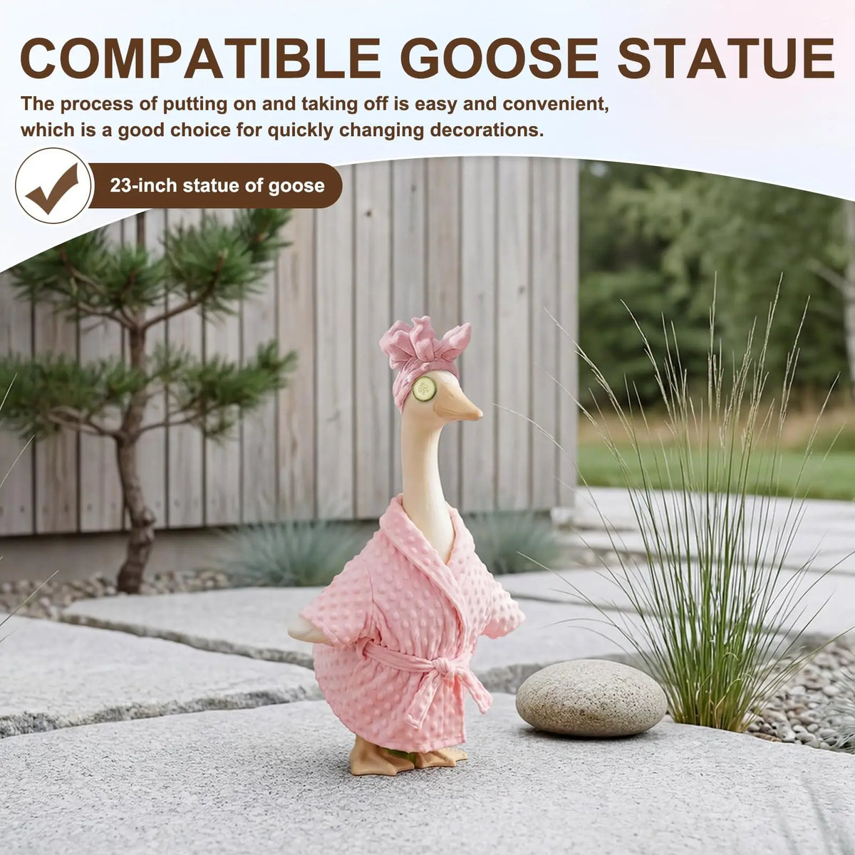 A pink goose statue with a ruffled outfit stands on a gray stone surface outdoors.