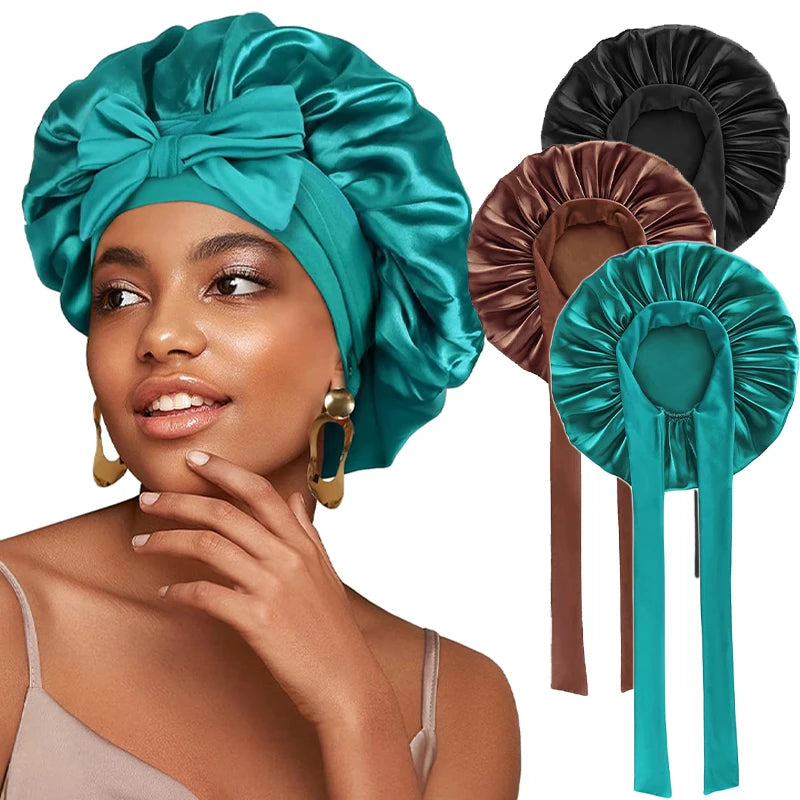 A woman wearing a teal satin sleeping bonnet and a matching fabric headband with adjustable ties.