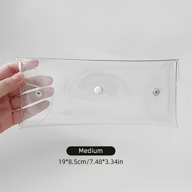 A hand holds a clear PVC cosmetic bag designed for waterproof storage of makeup brushes and other items.