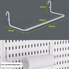 A white desktop pegboard organizer with a horizontal bar, hooks, and shelves mounted on a white panel.