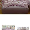 A set of floral pink duvet cover, pillowcases, and a flat sheet displayed on a bed.
