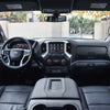 Interior view of a Chevrolet Silverado or GMC Sierra showing a custom fit dashboard cover installed.