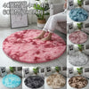A collection of shaggy circle area rugs in various colors including pink, blue, gray, and brown.