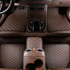 Interior view of a car with brown quilted PU leather floor mats and console.