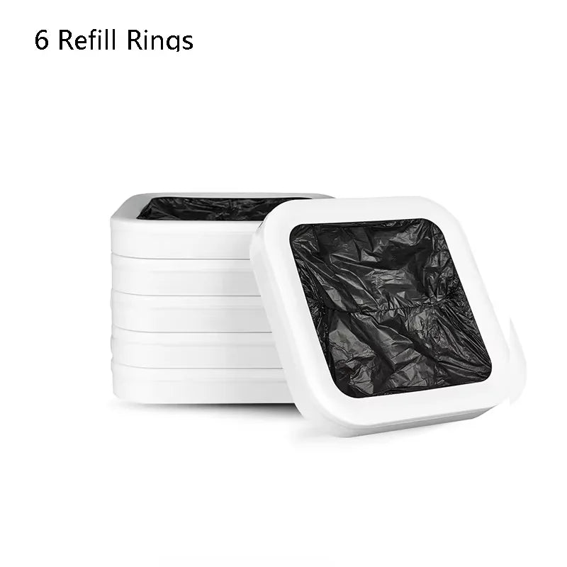 Six white refill rings stacked next to a white trash can with a black liner.