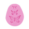 Pink silicone mold shaped like a butterfly for crafting soap, chocolate, or resin.