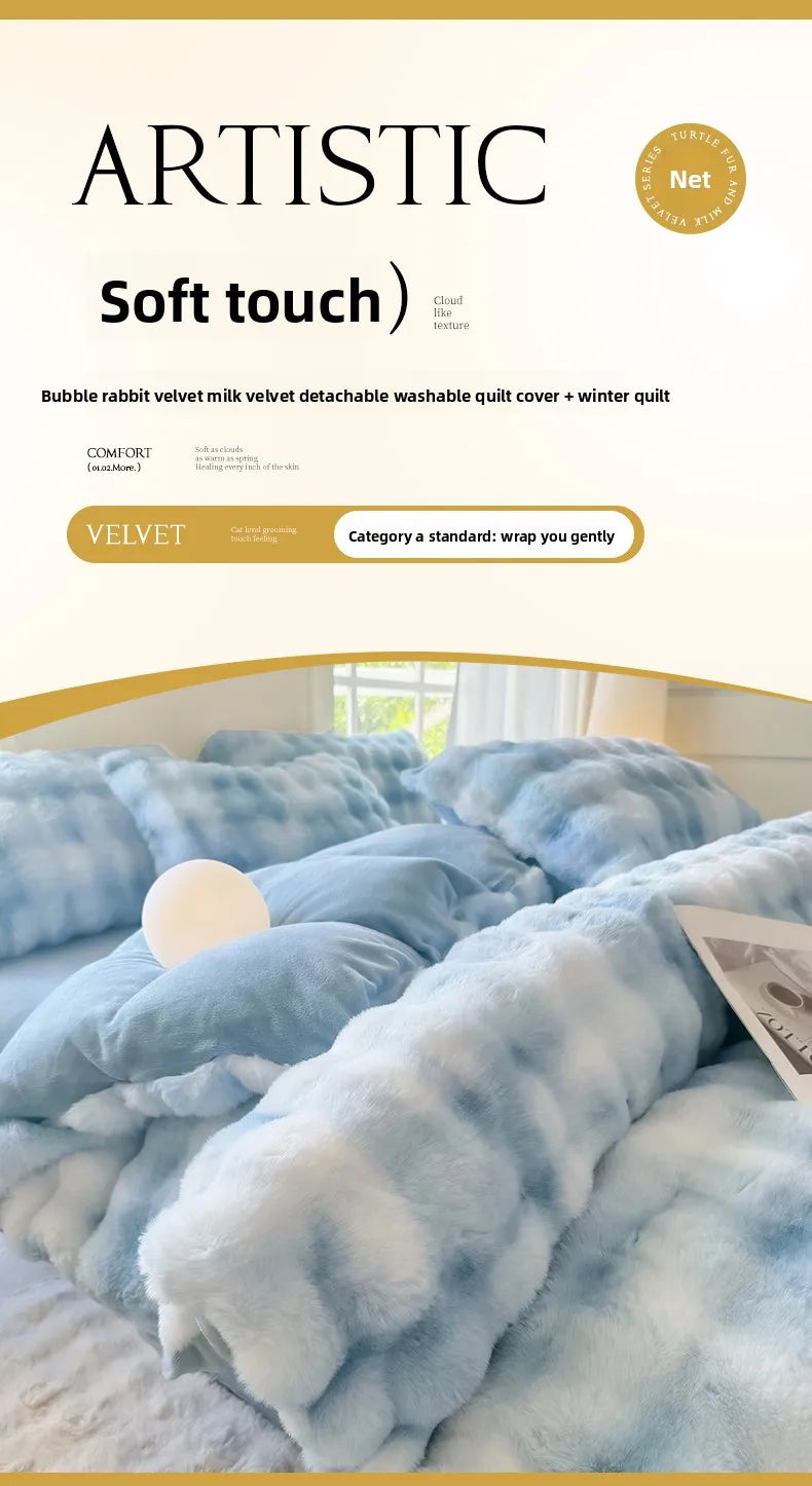 A close-up of a light blue fluffy fleece duvet cover with a rabbit pattern on a bed.