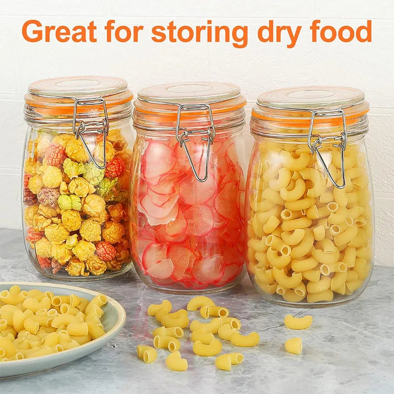 Three glass mason jars filled with dry food including fruit and pasta noodles