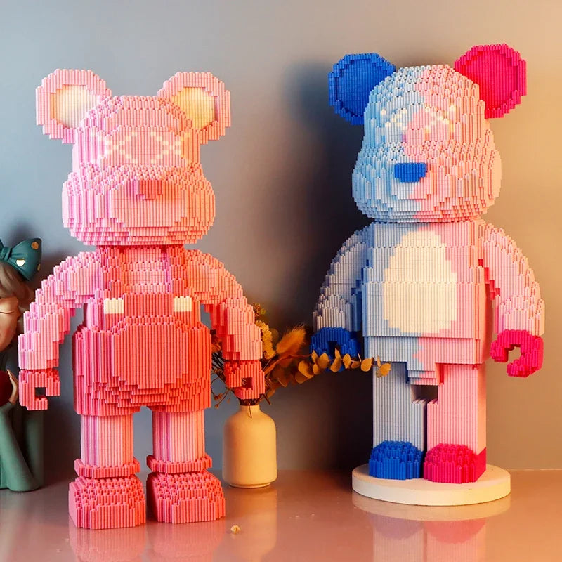 Two pink and blue mini angry bear LED building block figures standing on a surface.
