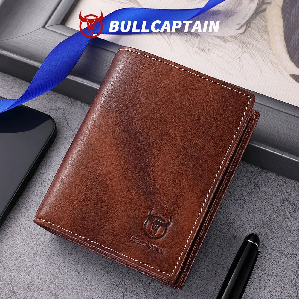 A brown genuine leather men's bifold wallet with stitching is shown next to a blue ribbon and a black pen.