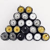 A collection of ten 1:64 scale alloy car wheels and tires, featuring black and gold finishes.