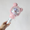A hand holds a plush pink cover for a SEVENTEEN official light stick, featuring a clear dome and a purple crystal.