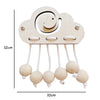 A wooden cloud shaped Montessori busy board with hanging round wooden beads for toddlers