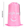 A pink drawstring laundry bag with the text 'wash me' printed on it.