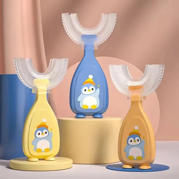 A set of U-shaped silicone toothbrushes for kids in yellow and blue, displayed on a light wooden stand.