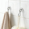 Self-adhesive stainless steel wall hooks hanging a beige towel on a white tiled surface
