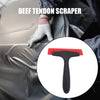 A hand wearing a glove is using a black beef tendon scraper tool on a dark surface.
