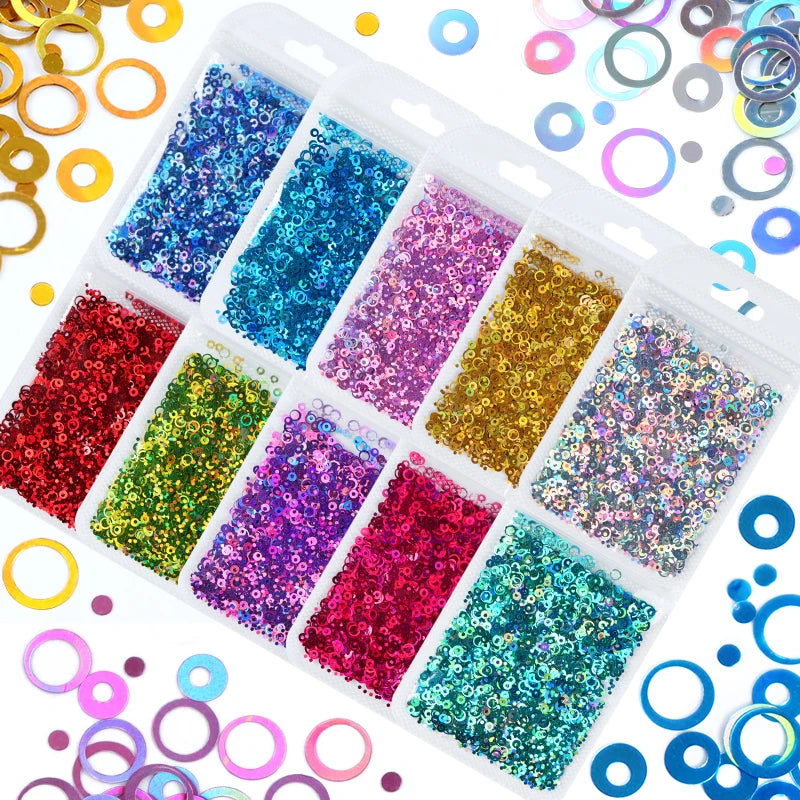A clear plastic tray filled with various colors of shiny holographic star sequins for resin crafts