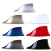 A collection of five shark fin car antennas in various colors including silver, beige, white, blue, and black.