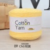 A spool of yellow cotton yarn labeled as Cotton Yarn 100g for knitting and crochet.