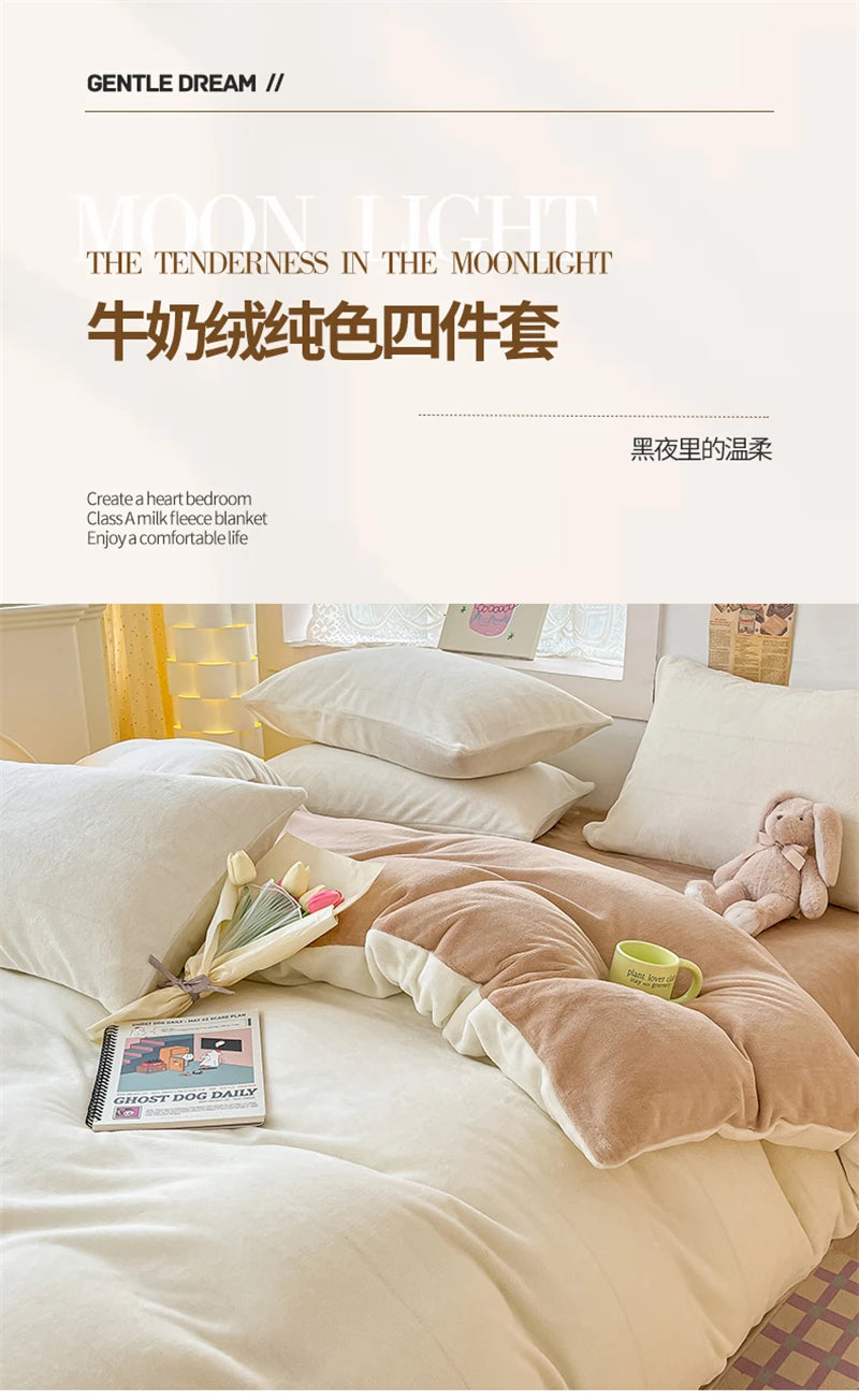 A set of four soft, light-colored milk velvet bedding items including a duvet cover and pillows on a bed.