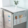 A refrigerator dust cover with storage pockets is displayed on a countertop, featuring a white and green floral pattern.