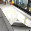 White marble peel-and-stick wallpaper featuring yellow veining installed on a kitchen countertop.
