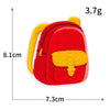 A bright red iron-on patch shaped like a backpack with yellow accents.
