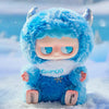 A fluffy blue MONBOO collectible blind box featuring a face and white trim, resting in the snow.