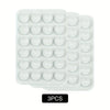 A pack of three white reusable silicone suction phone mounts in a plastic tray.