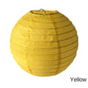 A round yellow paper lantern with a black hanger.