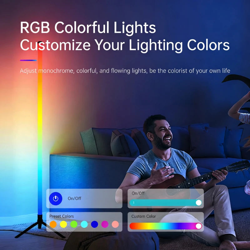 A man is sitting on a couch with an LED RGB floor lamp casting colorful ambient light onto the room.