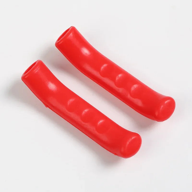 A pair of red silicone bicycle brake lever covers lying on a white background.