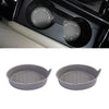 Two gray silicone coasters with a textured surface and rhinestone detailing for car cup holders