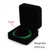 Black velvet bangle box with a green bangle inside