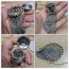 Handcrafted stainless steel coin purse with a retro design featuring intricate mesh and coin elements.