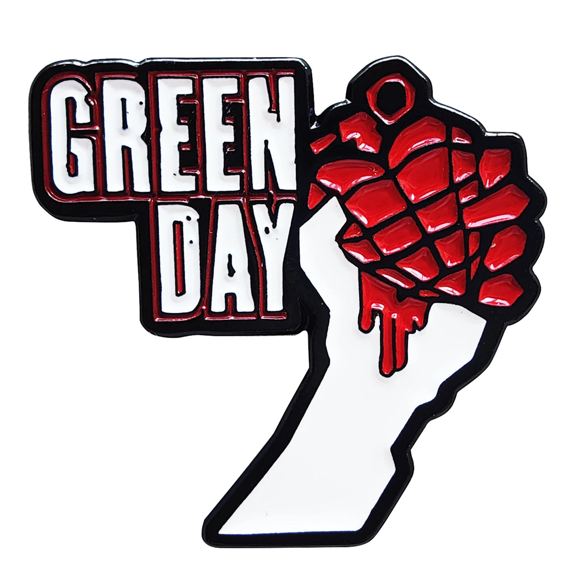 A black and white pin featuring the text GREEN DAY and a red fist design.