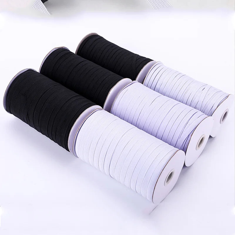 Rolls of black and white polyester elastic bands for sewing and crafts