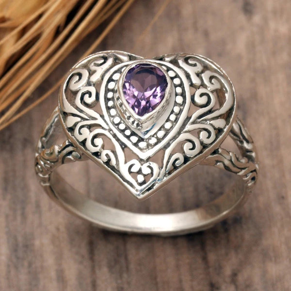 Silver vintage heart ring featuring a purple cubic zirconia gemstone set in an ornate design.