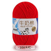 A ball of red milk cotton blend yarn labeled for knitting and crochet projects.