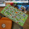 A large gaming mouse pad featuring a vintage city road design on a green background.