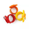 A set of orange and yellow silicone wristbands shaped like dinosaurs for a kids digital watch.