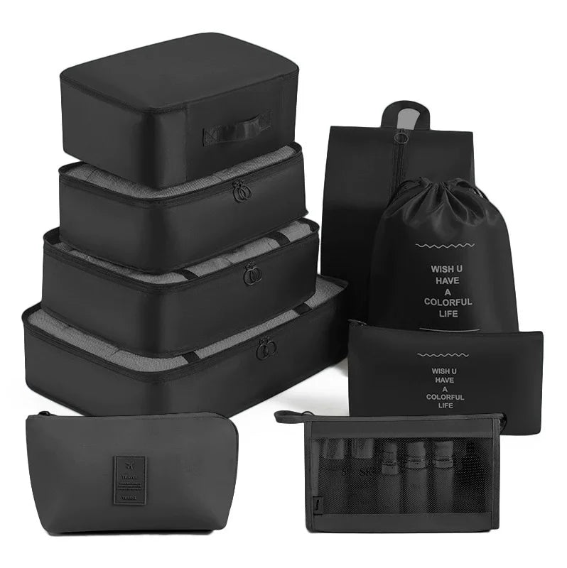 A set of black travel packing cubes and storage organizer bags.