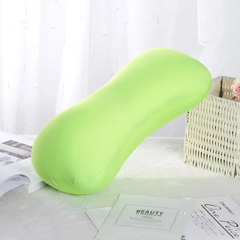 A bright lime green bolster pillow designed for neck and back support, resting on a white surface.