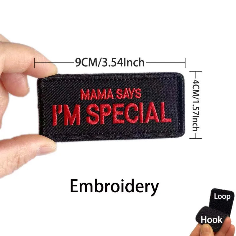 Black embroidered patch with red text saying Mama Says I'm Special