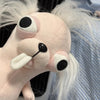 A light pink plush chihuahua dog keychain pendant with large black eyes and white fur.