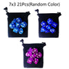 A set of seven 21-sided polyhedral dice in random colors stored in a black fabric pouch.