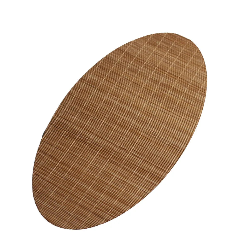 A round, brown bamboo tea mat with a fine vertical woven texture.